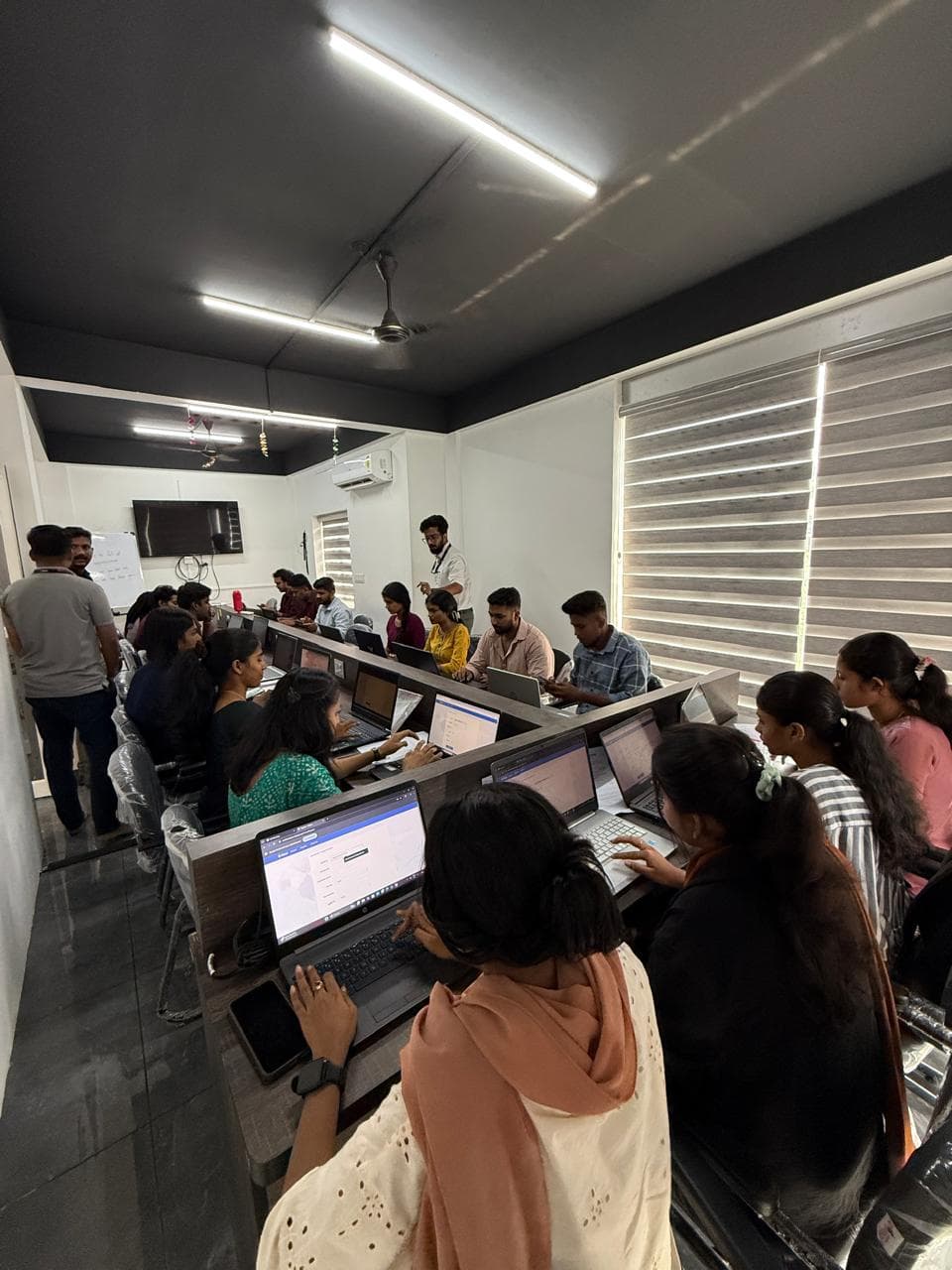 Students at Future Optima IT Solutions taking part in a live placement drive on laptops at the Chembumukku campus